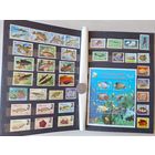 Альбом с марками - фауна морей и рек, рыбы, крабы, акулы, дельфины, киты, раки и др.